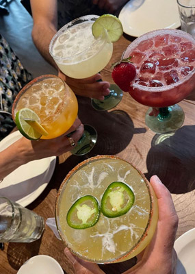 Four margarita glasses in different flavours